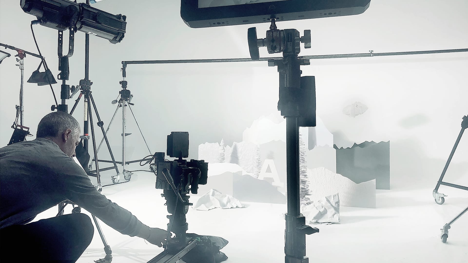 Paper crafted shapes framing a Bally winter product